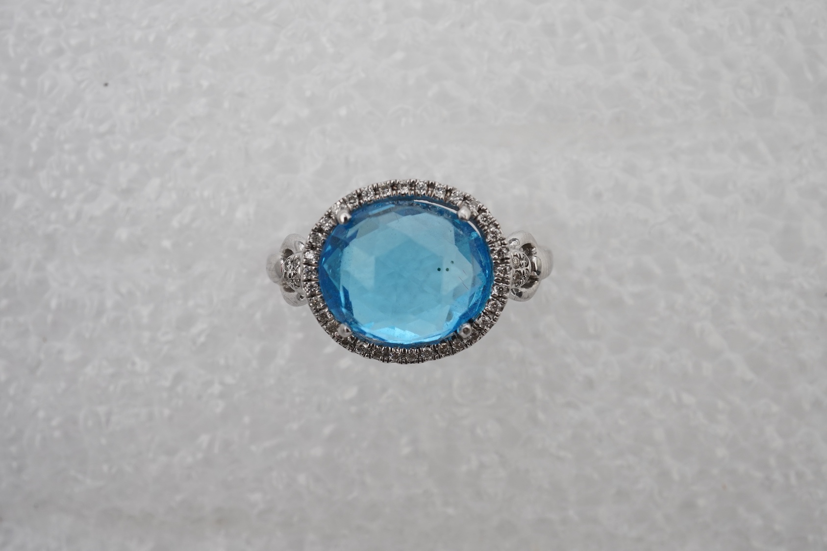A blue topaz and diamond ring